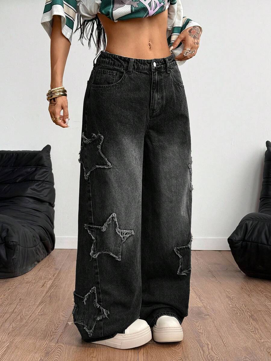 Women's loose fit baggy jeans in washed denim featuring star patches, slant pockets, and a mid-rise cut.