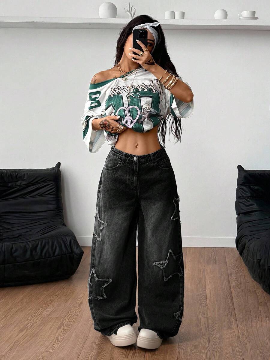 Women's loose fit baggy jeans in washed denim featuring star patches, slant pockets, and a mid-rise cut.
