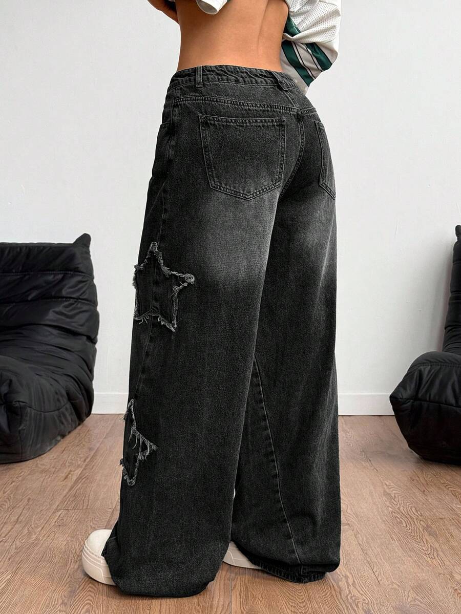 Women's loose fit baggy jeans in washed denim featuring star patches, slant pockets, and a mid-rise cut.