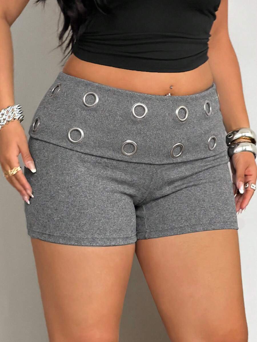 Women's black studded mini shorts crafted from stretch knitted fabric featuring an elastic waistband and skinny fit.