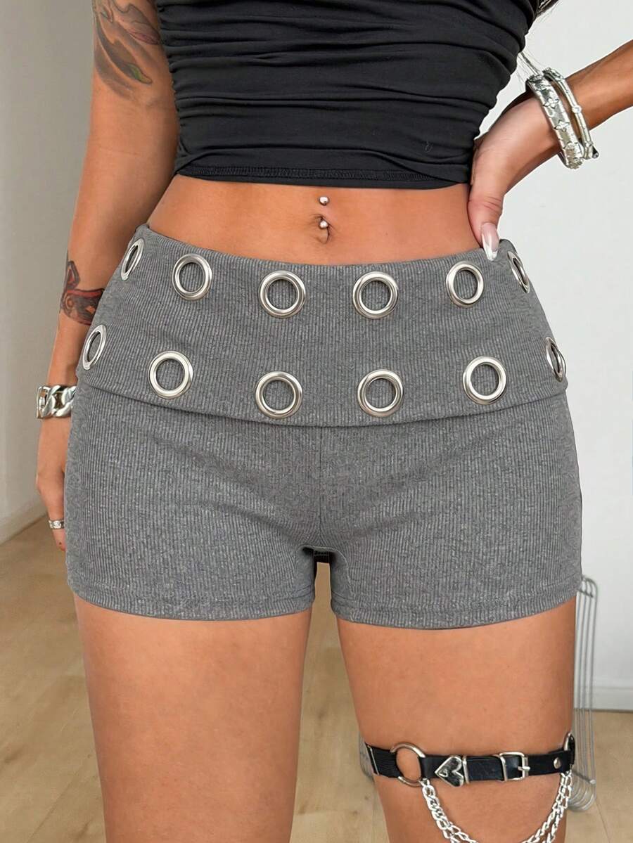 Women's black studded mini shorts crafted from stretch knitted fabric featuring an elastic waistband and skinny fit.