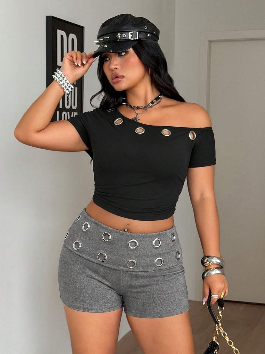 Women's black studded mini shorts crafted from stretch knitted fabric featuring an elastic waistband and skinny fit.