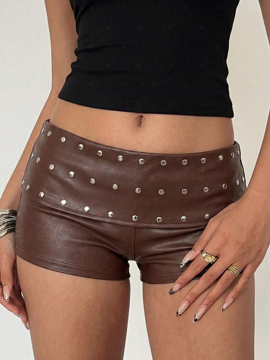 Women's studded PU ultra low waist mini shorts with zipper fly closure, skinny fit, mini length, and plain unlined design.