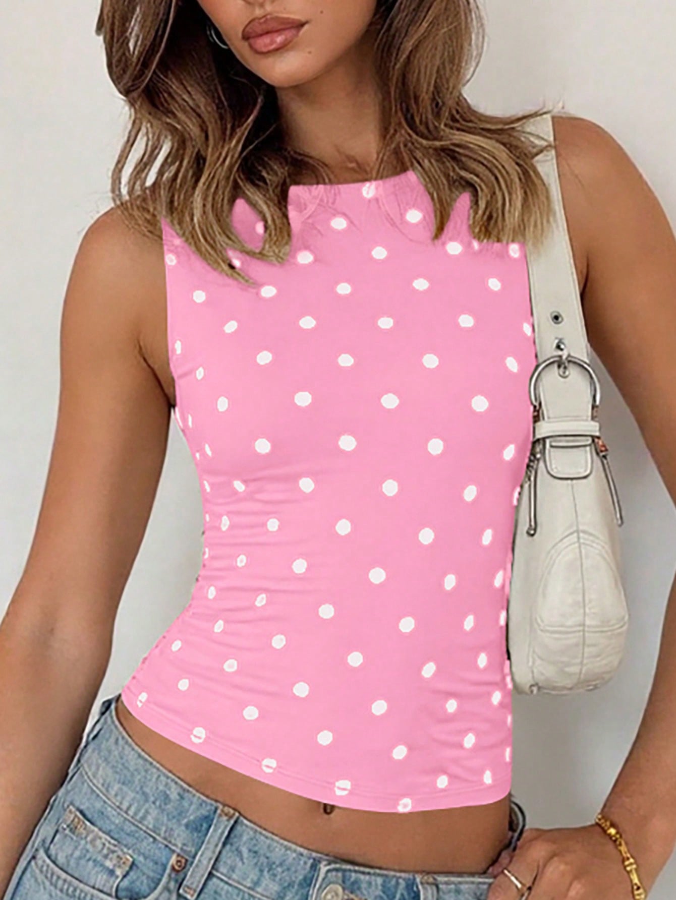 Women's polka dot sleeveless tank top with round neck, ruched rib-knit detail, regular hem, and slim fit casual style