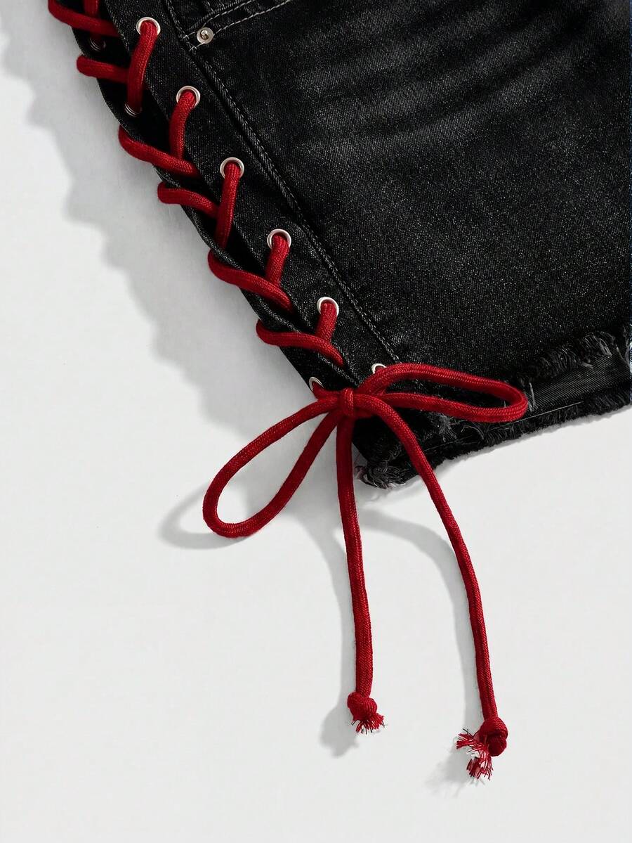 Plus size black gothic mini shorts with heart embroidery, graphic pocket pattern, lace-up detail, raw hem, and zipper fly