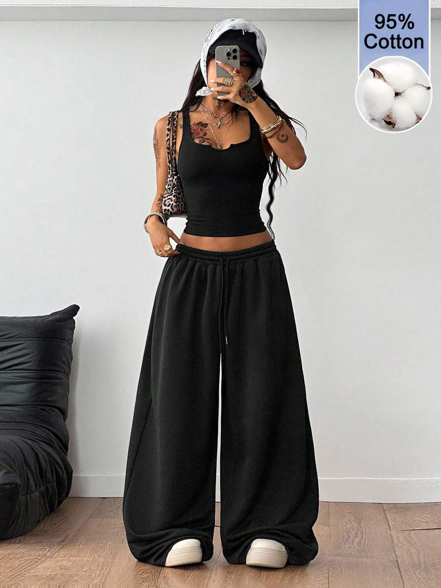 Women's two-piece casual outfit featuring a slim-fit camisole tank top with ruffle trim and button front paired with high-waisted wide leg pants.
