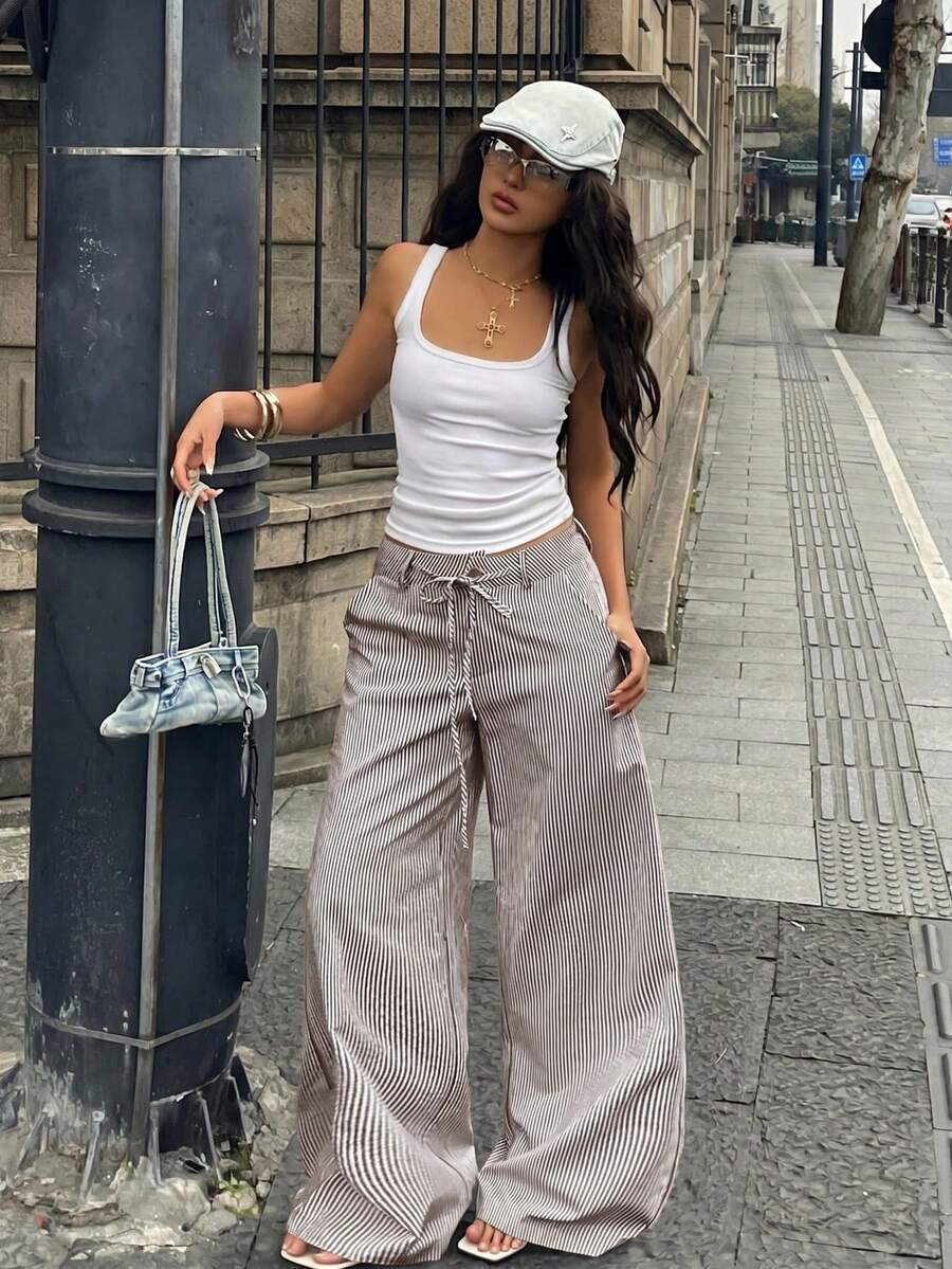 Women's casual straight leg striped woven pants featuring a low waist and zipper fly closure.