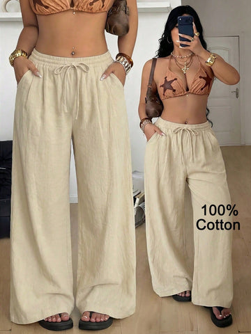 Women's loose straight leg cotton pants featuring a high waist with an adjustable drawstring knot and functional side pockets.