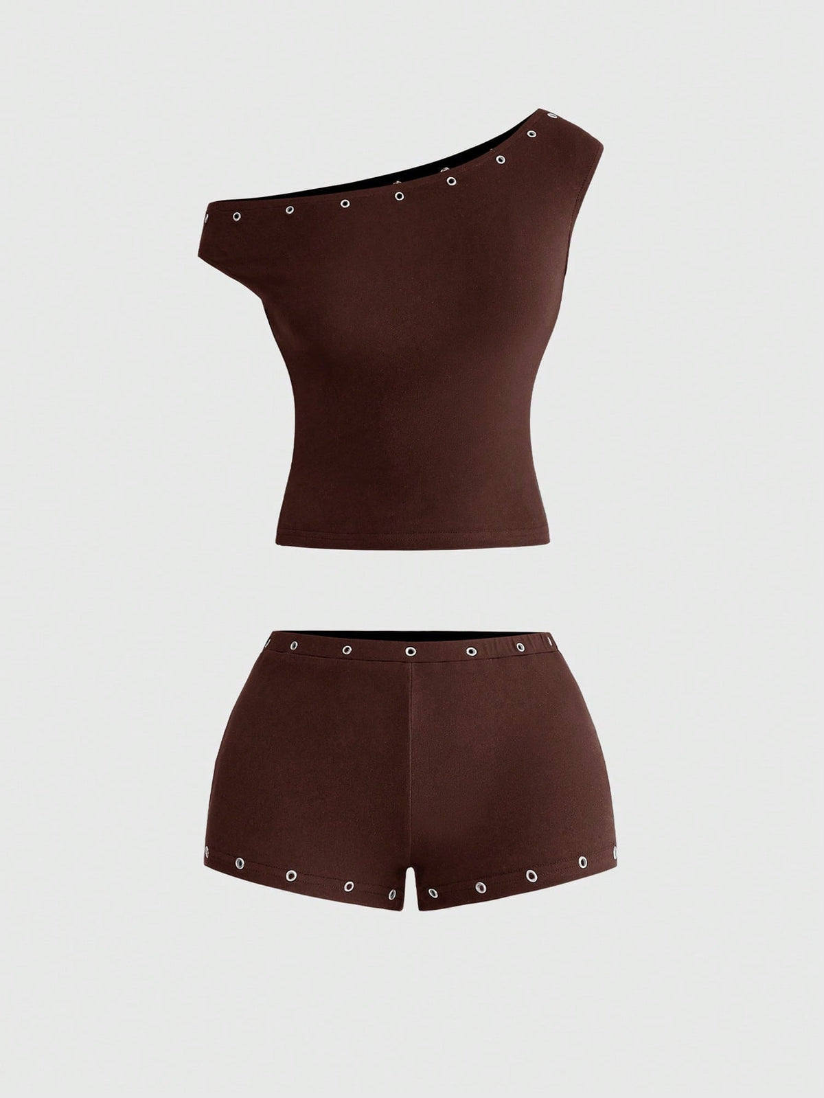 Women's two-piece outfit with an asymmetric neck studded grommet crop top and super low-rise mini shorts