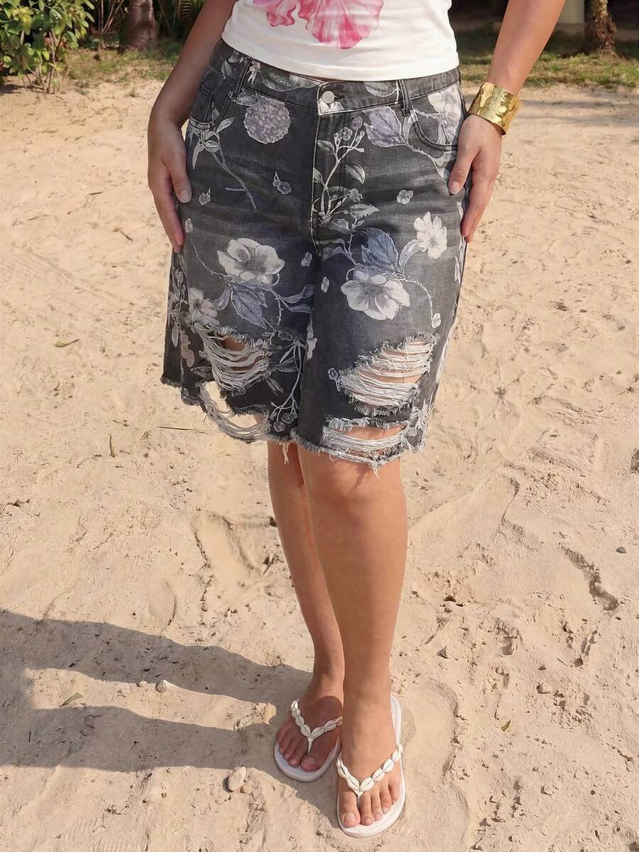 Women's loose wide-leg denim Bermuda shorts featuring vintage animal and paisley print with pockets and zipper fly.
