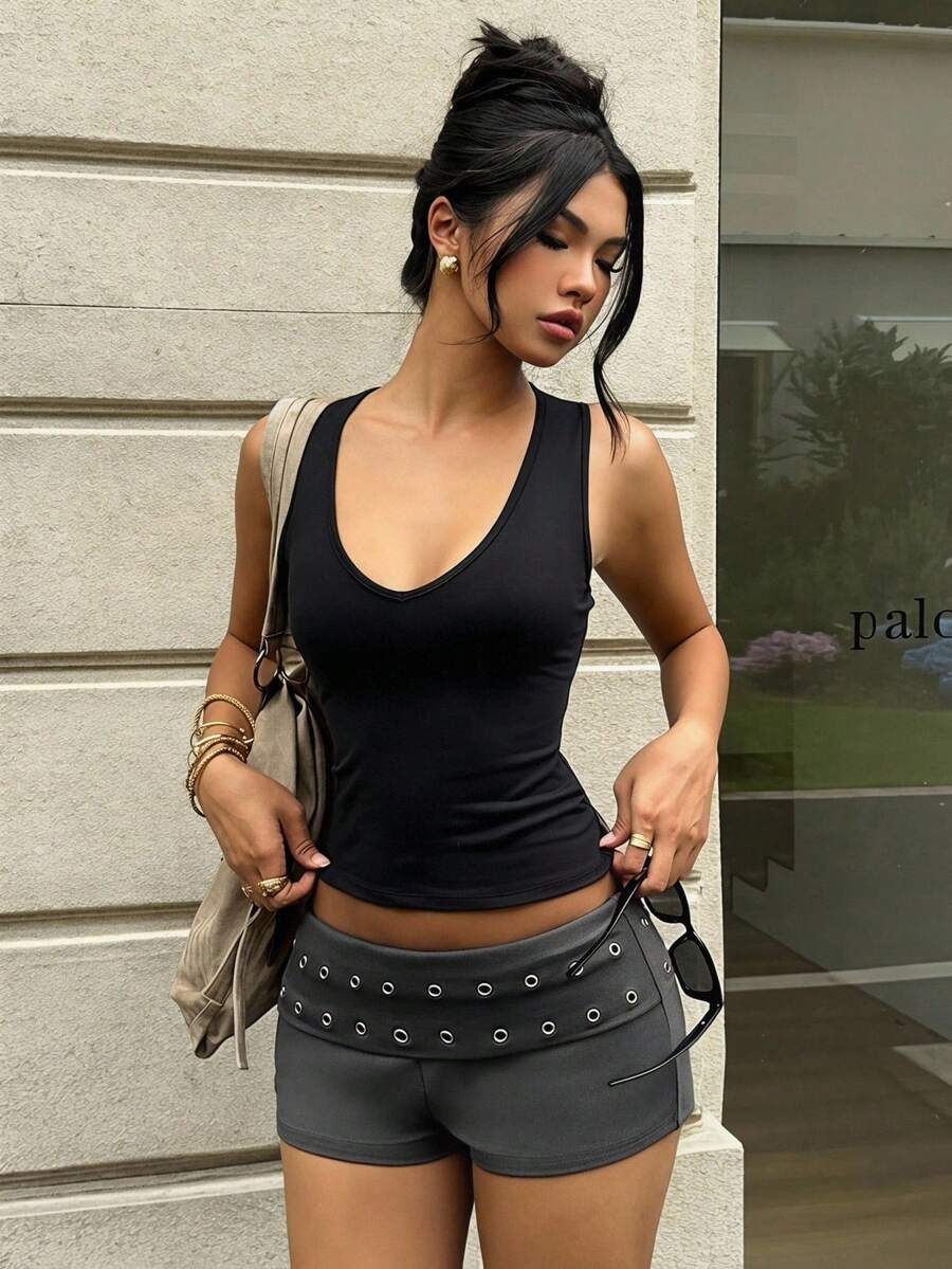 Women's studded PU ultra low waist mini shorts with zipper fly closure, skinny fit, mini length, and plain unlined design.