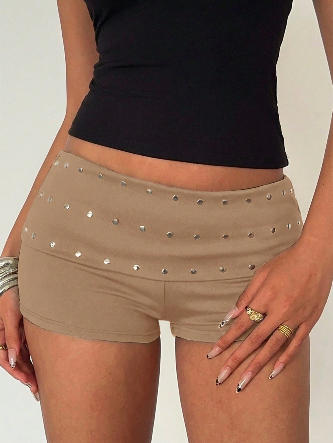 Women's ultra low waist mini shorts with rhinestone studded detailing, skinny fit, and mini length.