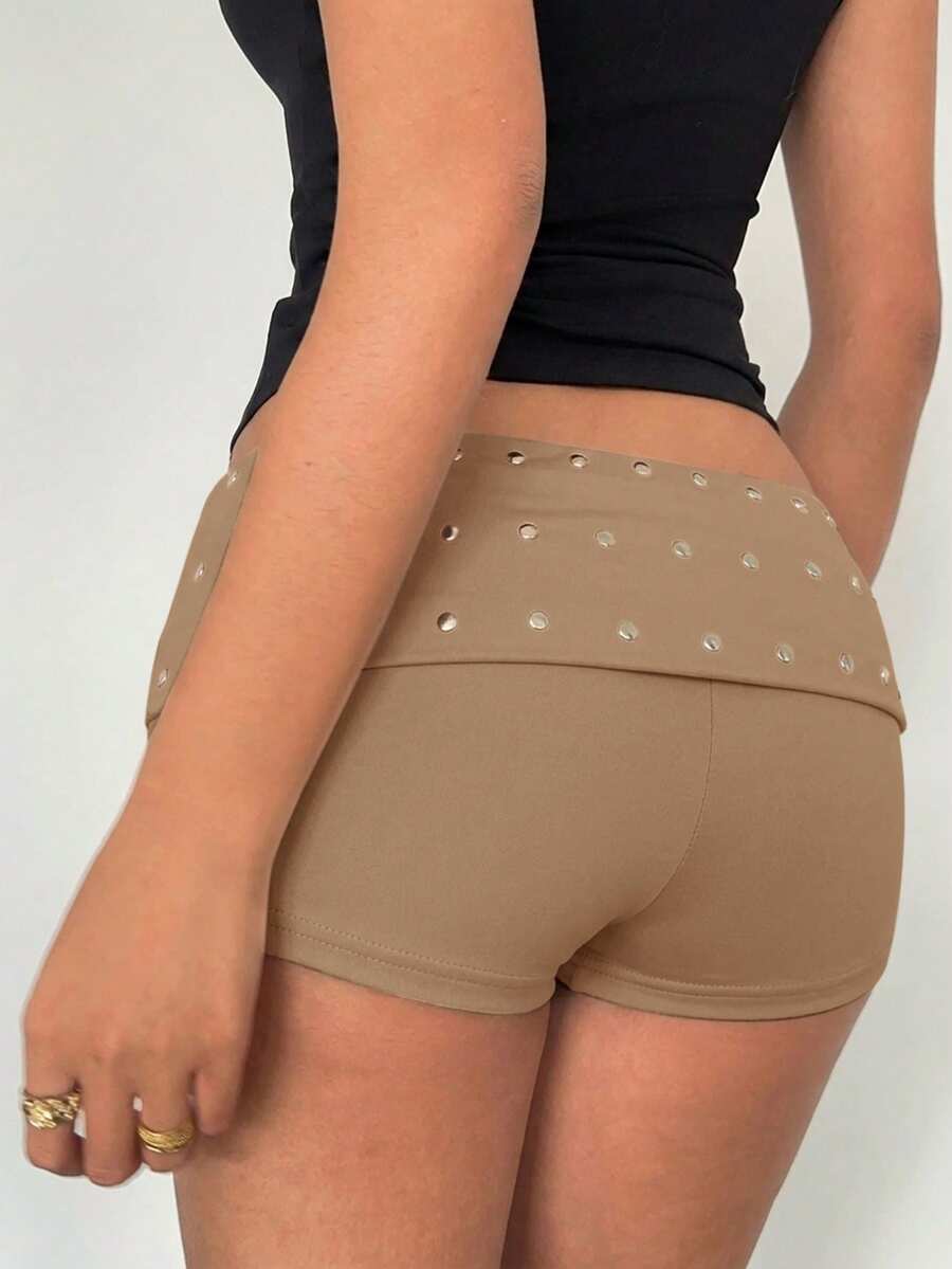 Women's ultra low waist mini shorts with rhinestone studded detailing, skinny fit, and mini length.
