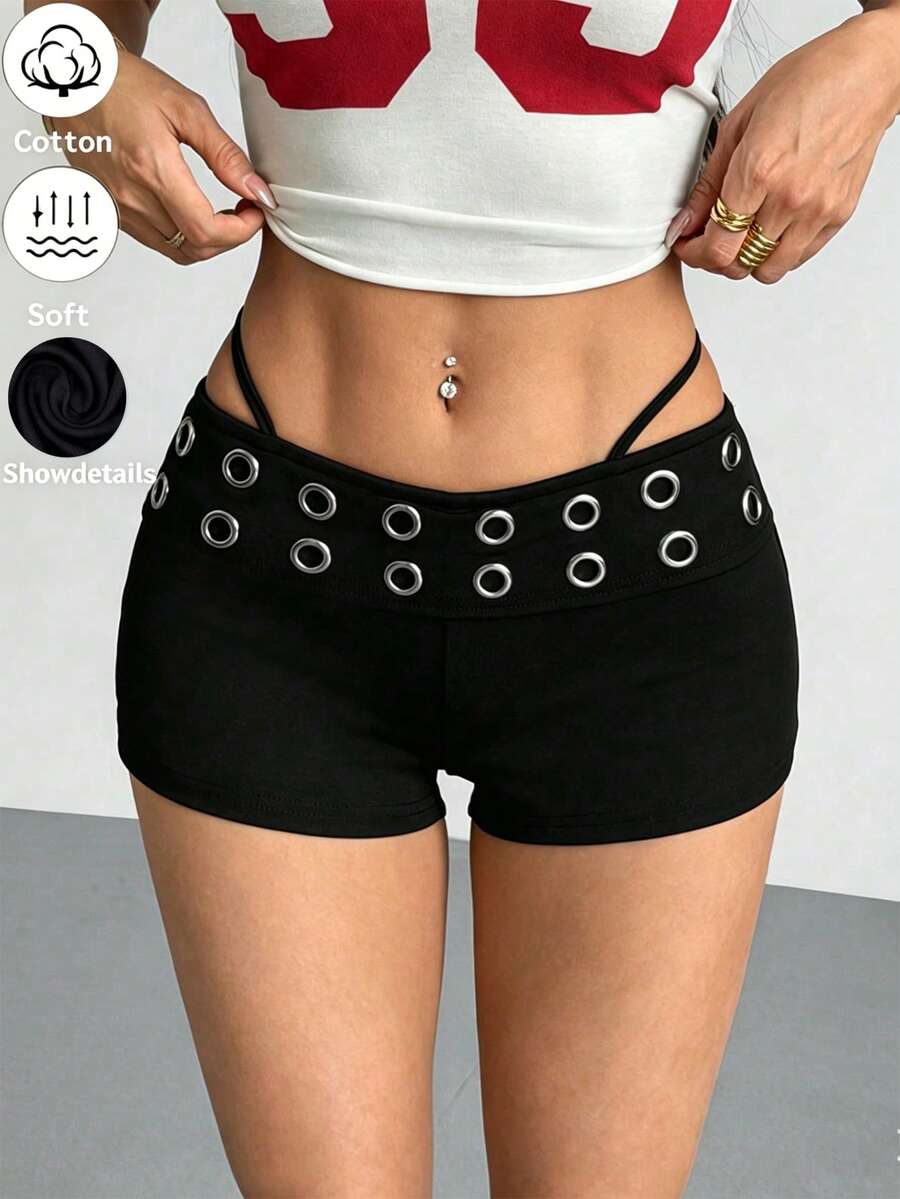 Women's casual track shorts with elastic waist, low-rise mini length, colorblock graphic pattern, and cut-out studded grommet eyelet details.