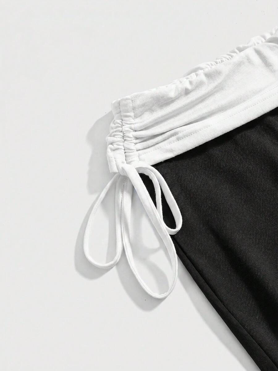 Women's low waist flare leg pants featuring an elastic drawstring waistband and ruched detail in knitted fabric.