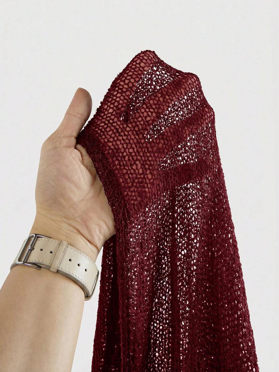 Women's casual hollow knit poncho top with boat neck, cloak sleeves, and asymmetrical hem