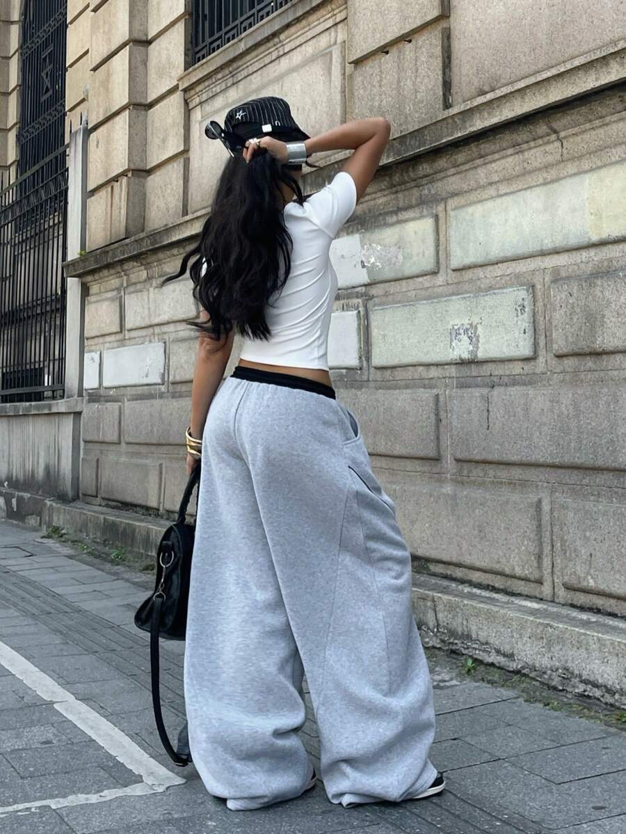 Women's casual grey plaid sweatpants featuring an elastic drawstring waistband, side pockets, and a relaxed loose fit.