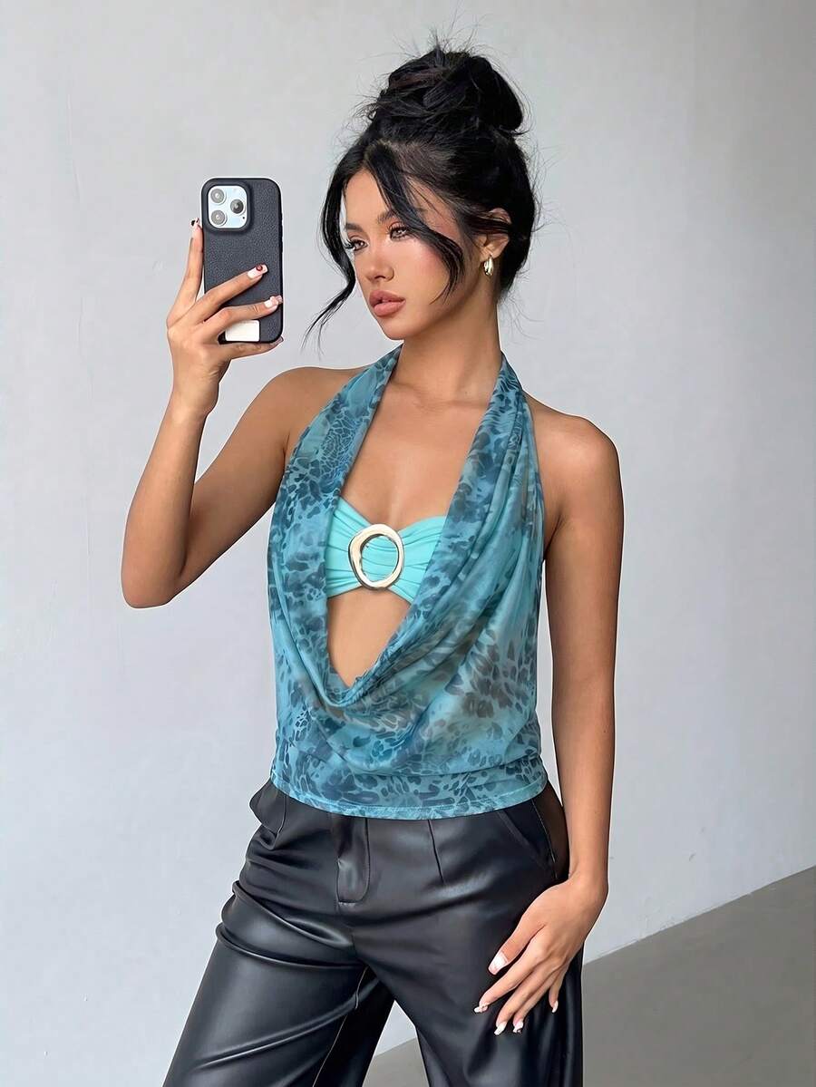 Brown and white polka dot semi-sheer halter camisole top with a plunging neckline, backless design, draped front, and metallic studded embellishments.