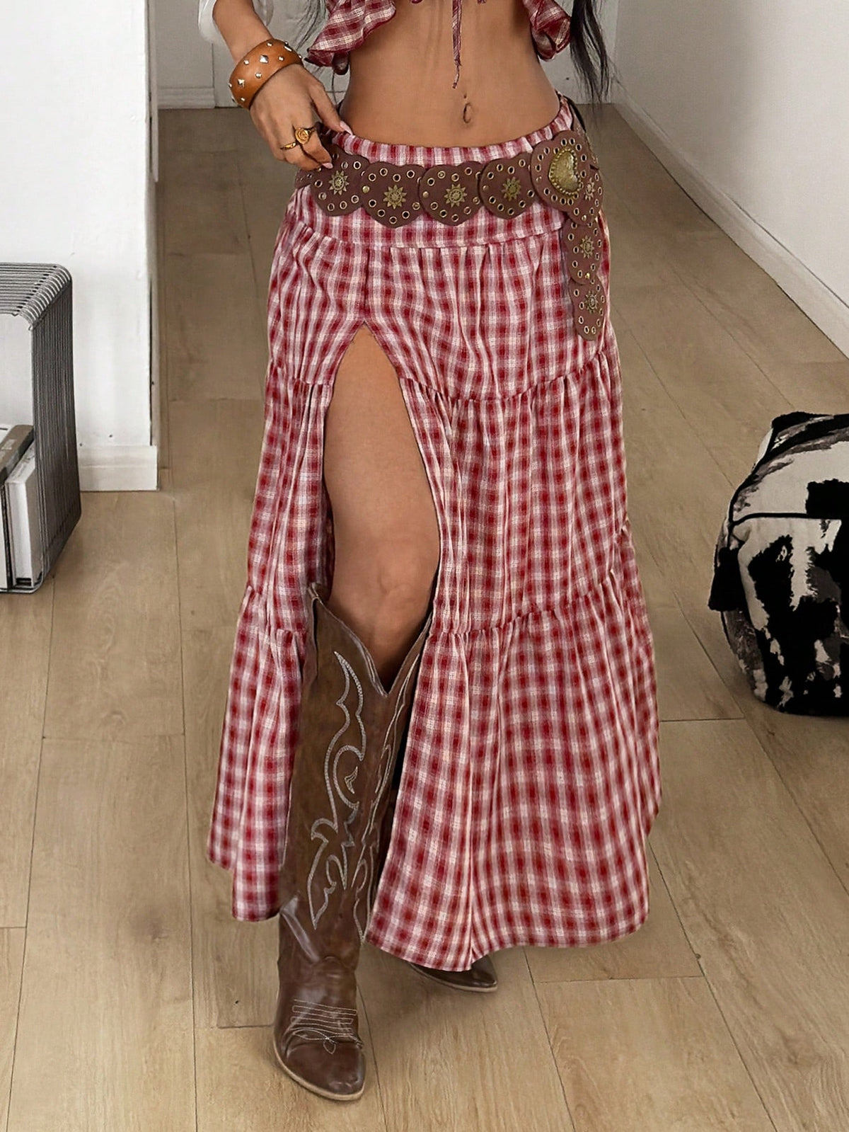 Women's red plaid long skirt featuring a low-rise waist and a side slit in lightweight woven fabric.