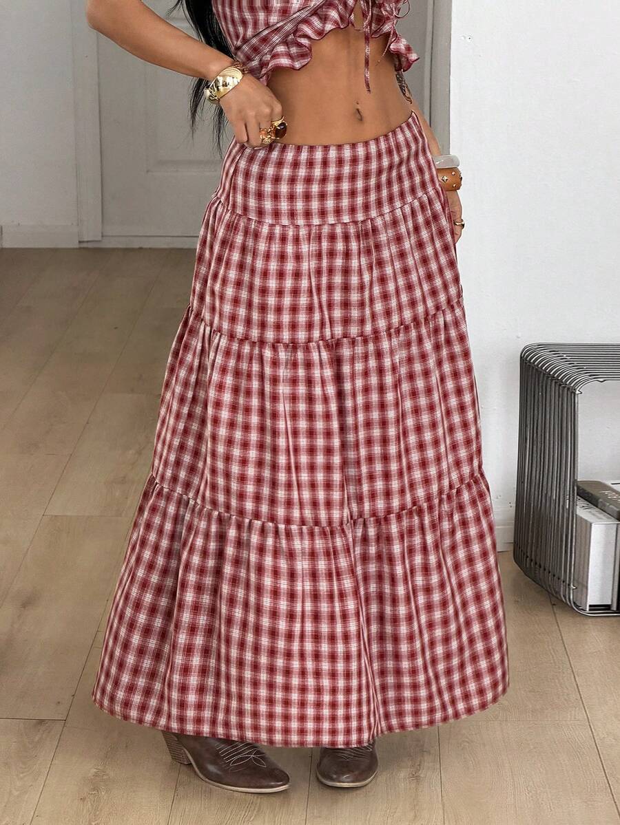 Women's red plaid long skirt featuring a low-rise waist and a side slit in lightweight woven fabric.