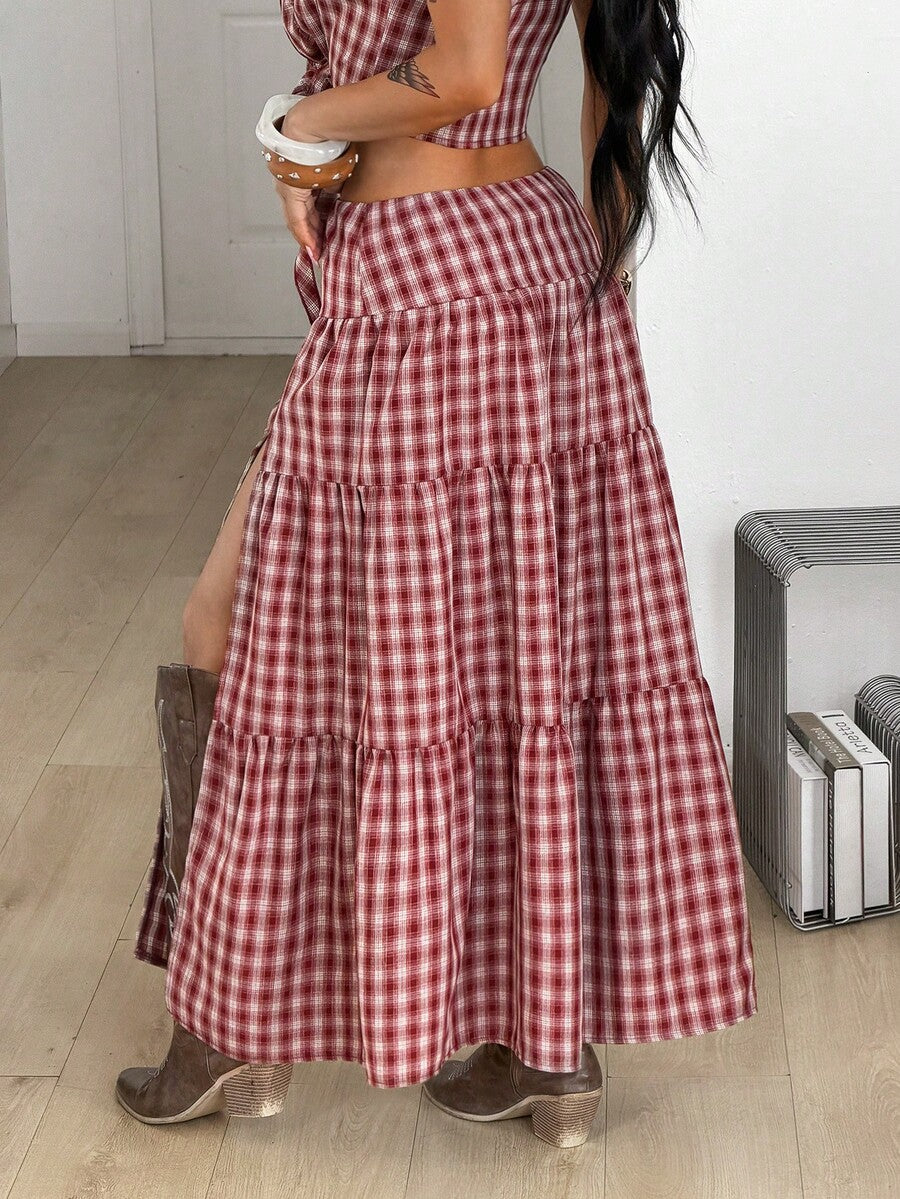 Women's red plaid long skirt featuring a low-rise waist and a side slit in lightweight woven fabric.