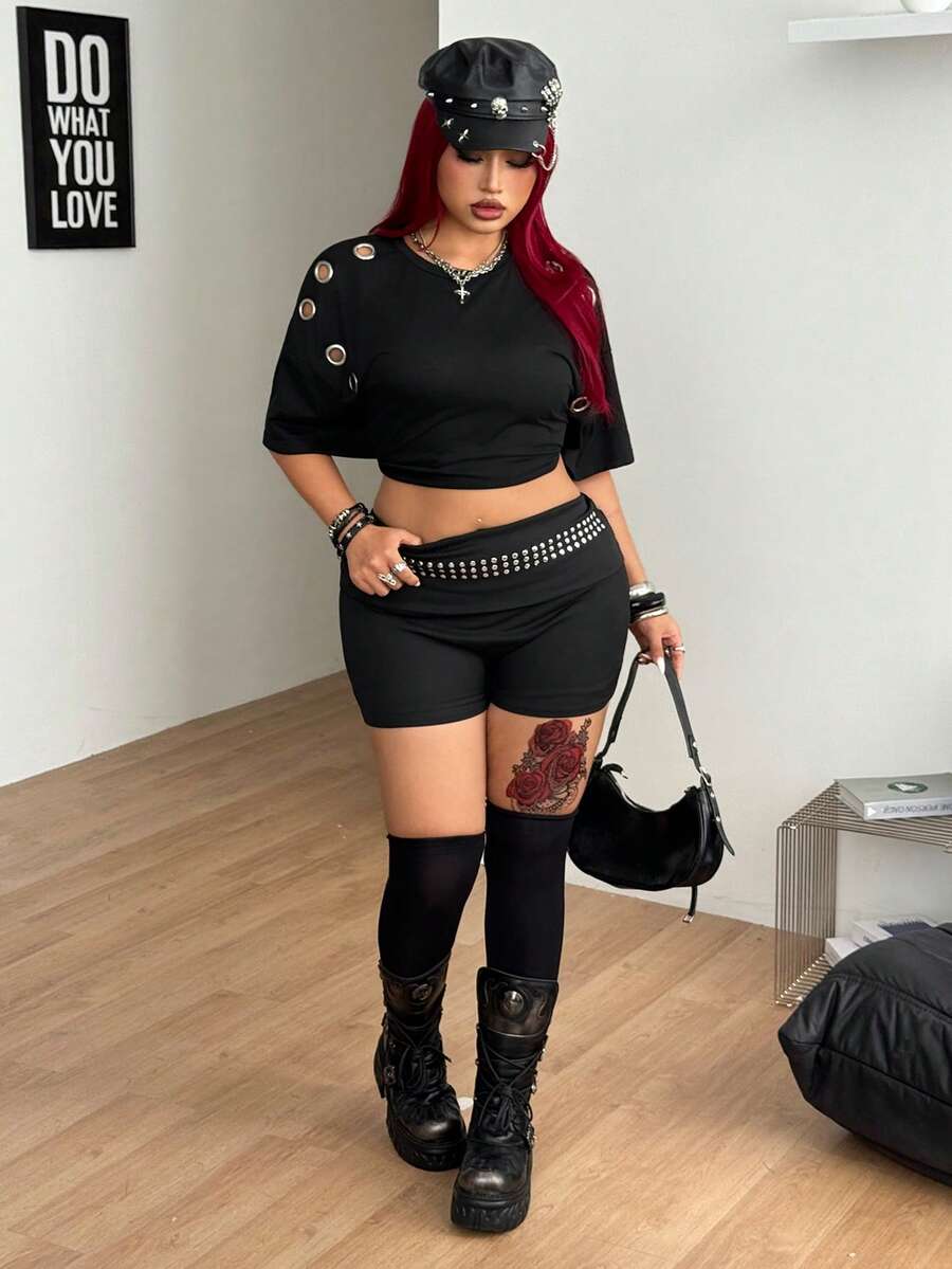 Women's black studded mini shorts crafted from stretch knitted fabric featuring an elastic waistband and skinny fit.