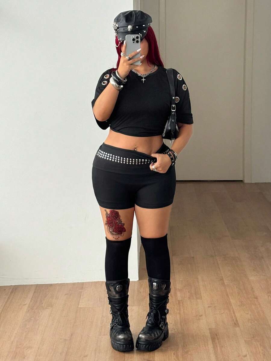 Women's black studded mini shorts crafted from stretch knitted fabric featuring an elastic waistband and skinny fit.