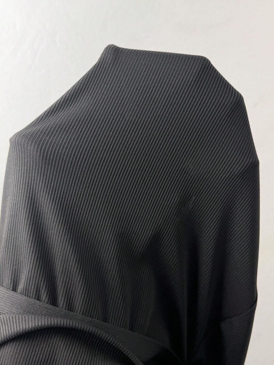 Women's black studded mini shorts crafted from stretch knitted fabric featuring an elastic waistband and skinny fit.