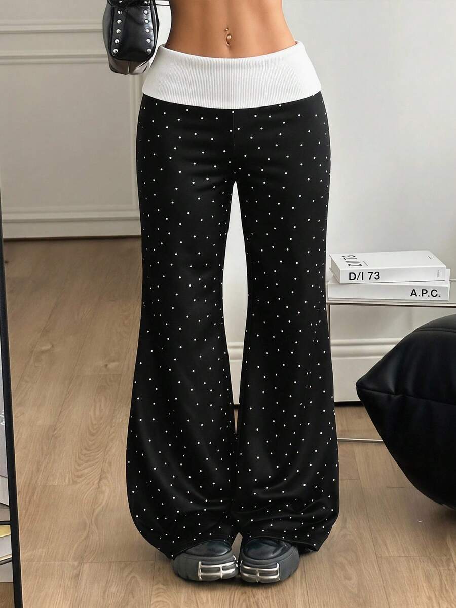 Women's black low waist wide leg flare sweatpants with rib-knit texture and contrast binding details.