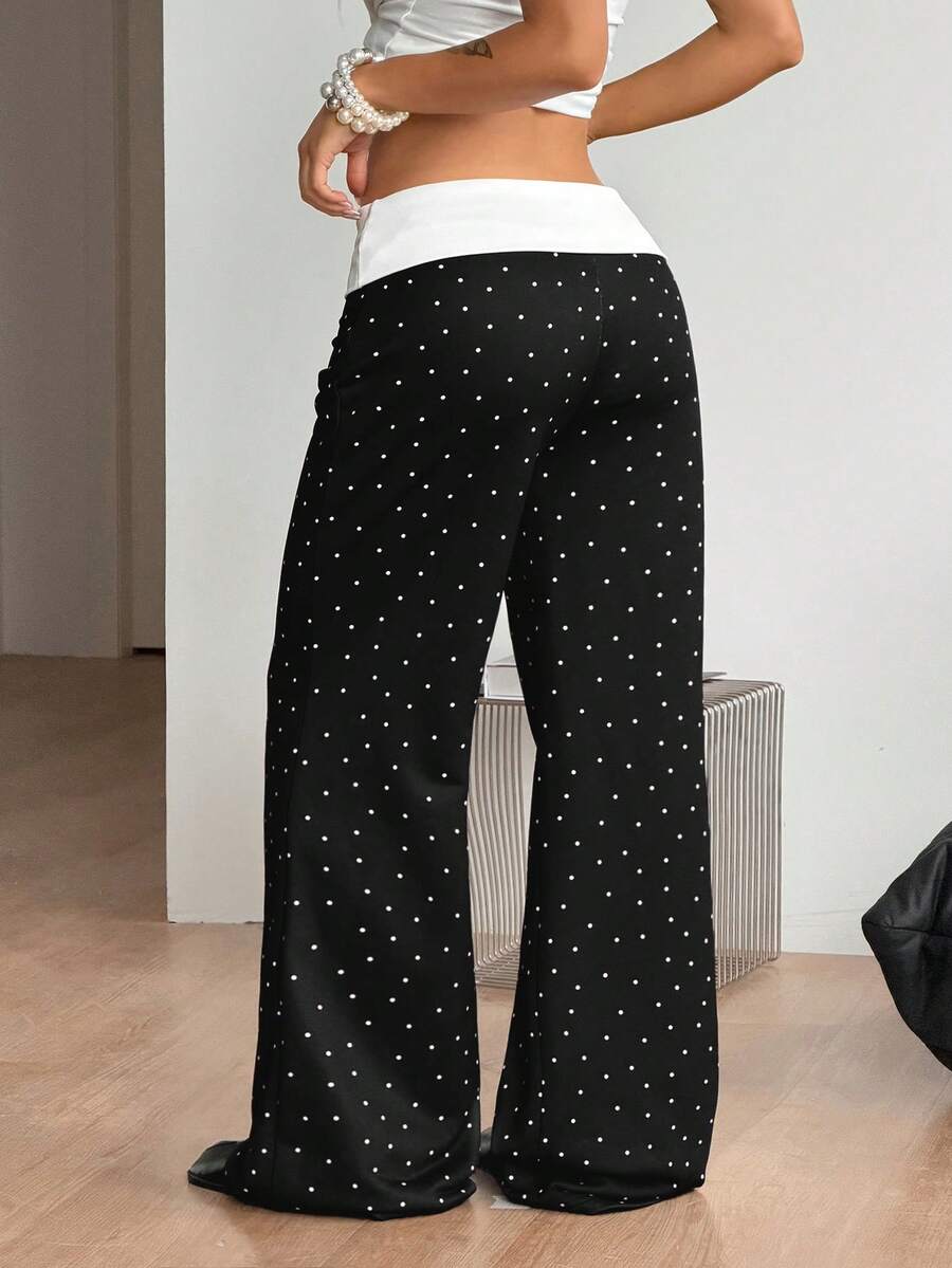 Women's black low waist wide leg flare sweatpants with rib-knit texture and contrast binding details.