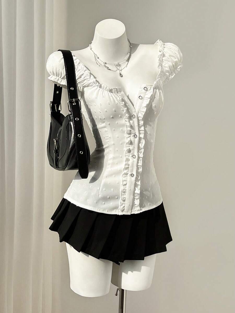 Women's black off-shoulder cap sleeve blouse with ruffled detailing and a tie-back design.