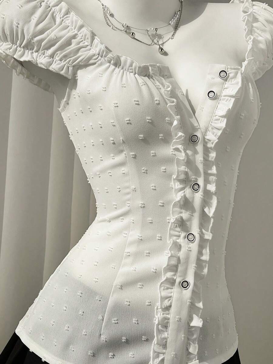 Women's black off-shoulder cap sleeve blouse with ruffled detailing and a tie-back design.