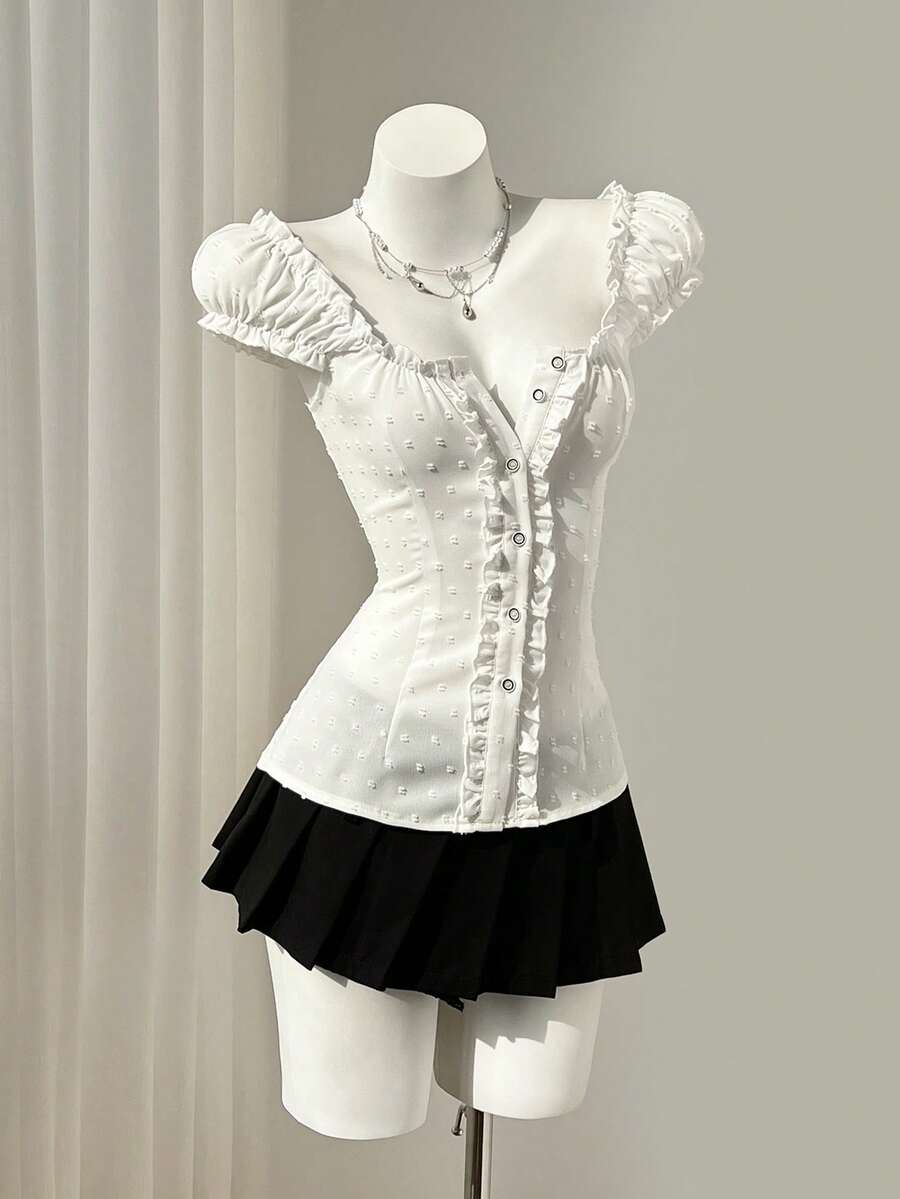 Women's black off-shoulder cap sleeve blouse with ruffled detailing and a tie-back design.
