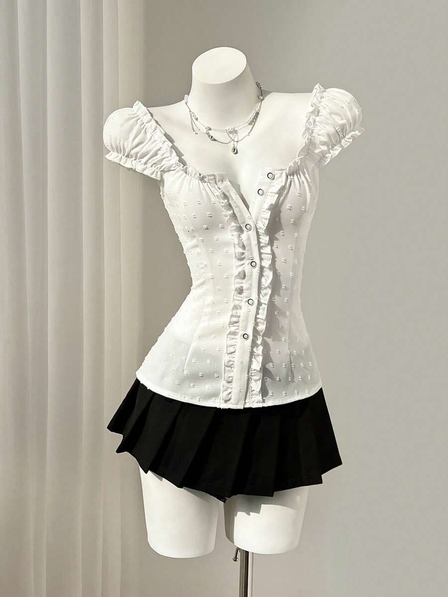 Women's black off-shoulder cap sleeve blouse with ruffled detailing and a tie-back design.