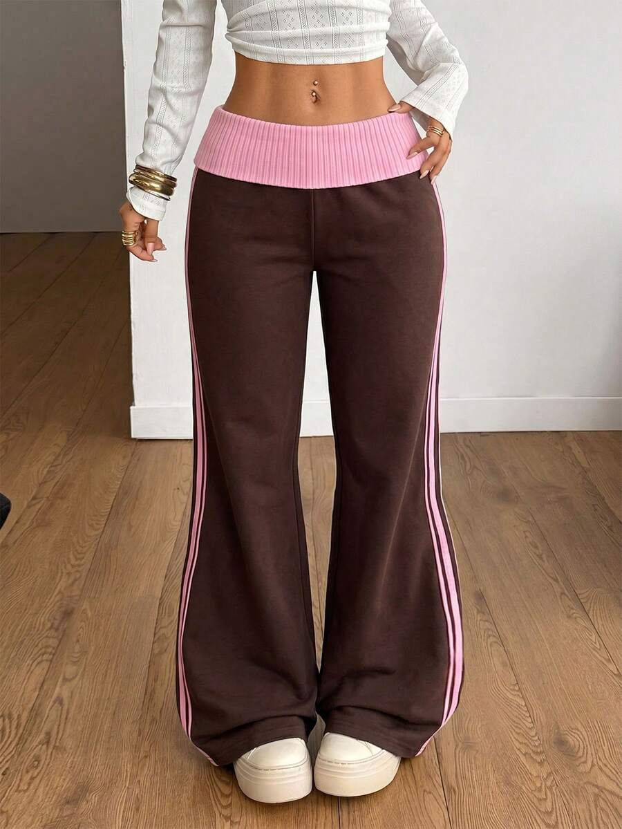 Women's wide leg flare sweatpants featuring a black and white colorblock contrast fold waistband and side stripe details.