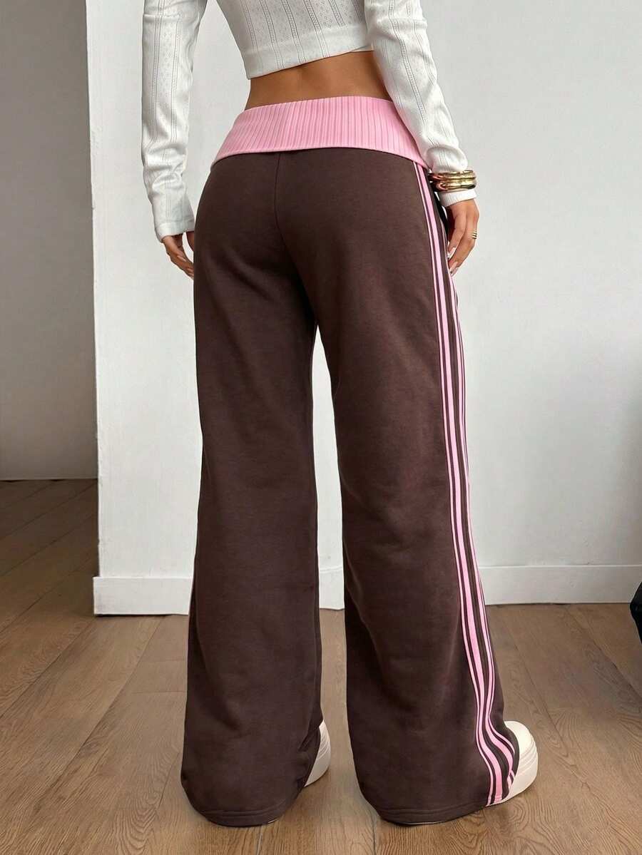 Women's wide leg flare sweatpants featuring a black and white colorblock contrast fold waistband and side stripe details.