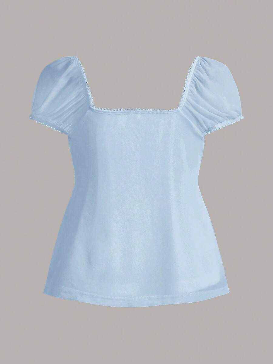 Women's black short puff sleeve top featuring a square neckline, ruched bust detail, and flared ruffle hem.