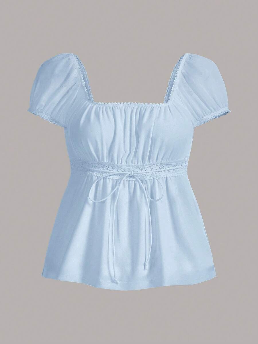 Women's black short puff sleeve top featuring a square neckline, ruched bust detail, and flared ruffle hem.