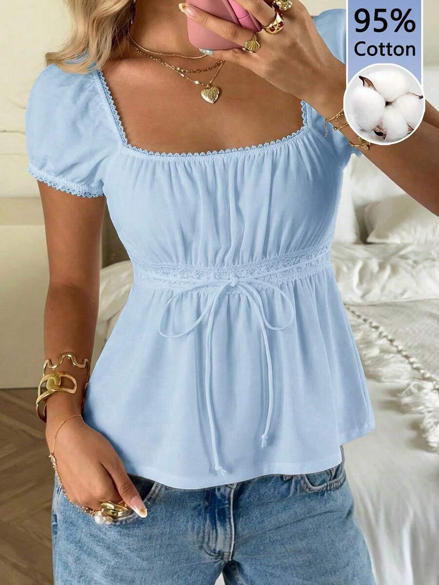 Women's black short puff sleeve top featuring a square neckline, ruched bust detail, and flared ruffle hem.