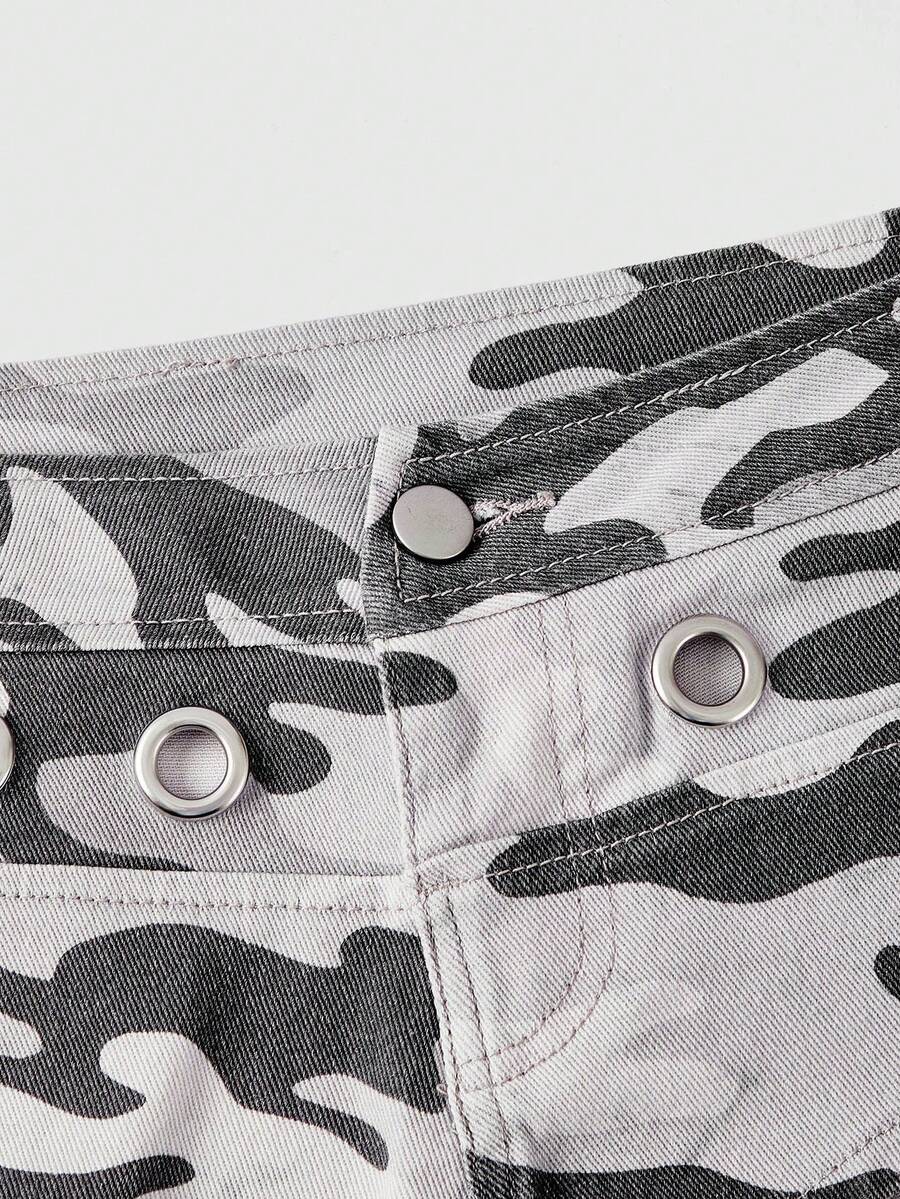 Women's ultra low waist camouflage mini skort shorts with zipper fly, button detail, and grommet eyelet accents.