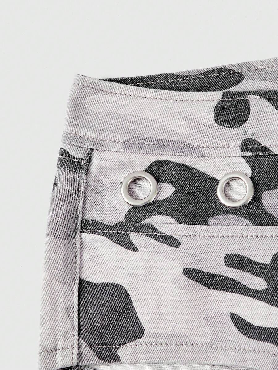 Women's ultra low waist camouflage mini skort shorts with zipper fly, button detail, and grommet eyelet accents.