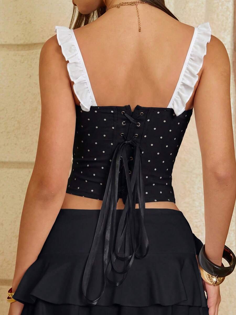 White cropped slim fit camisole top featuring ruffle lettuce trim, lace-up detail, and square neckline.