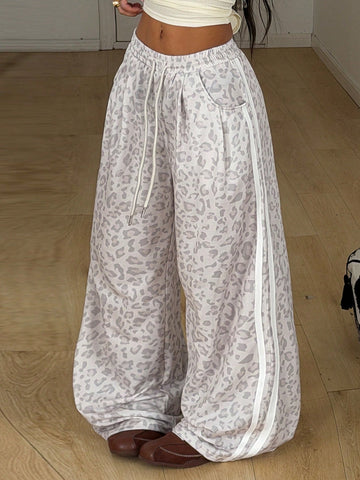 Women's casual straight leg baggy lounge pants in light grey with an adjustable drawstring waist and side pockets.