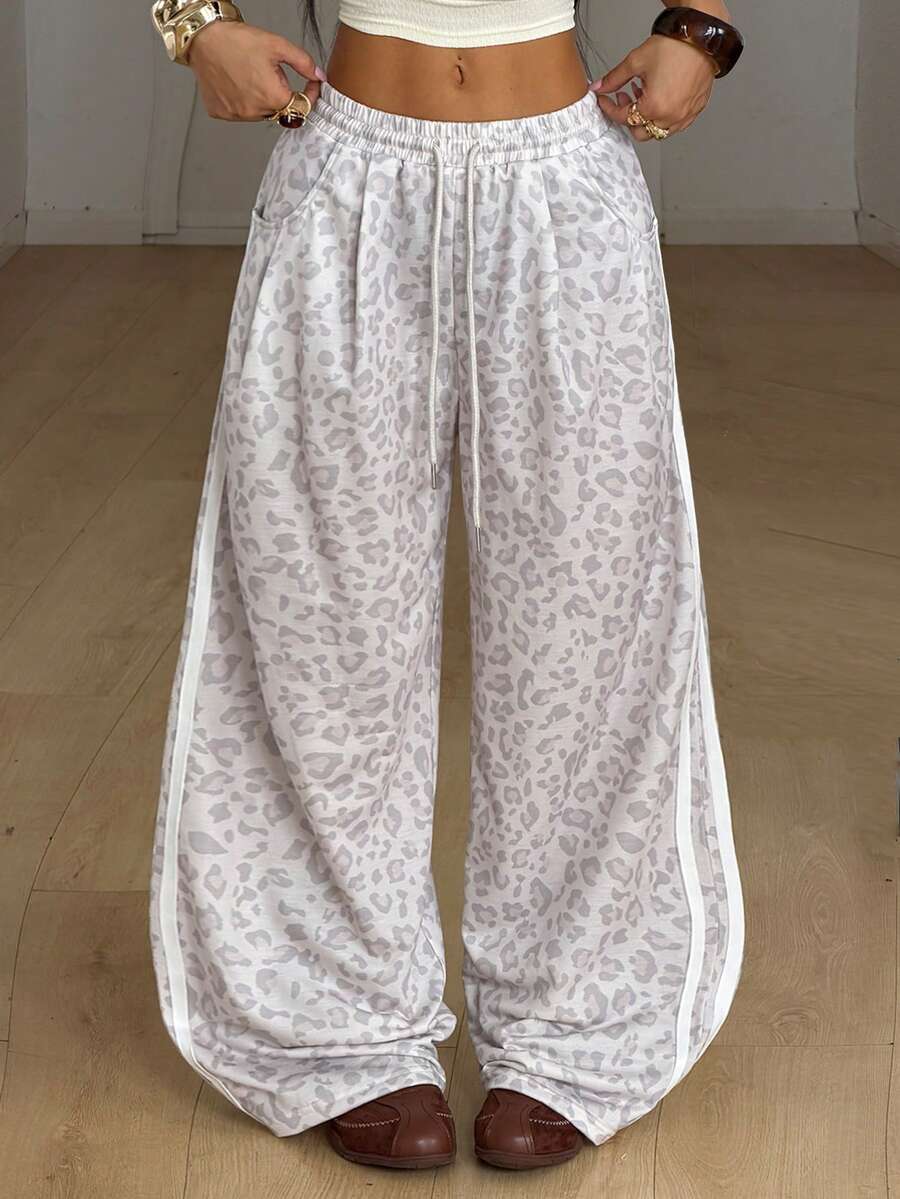 Women's casual straight leg baggy lounge pants in light grey with an adjustable drawstring waist and side pockets.
