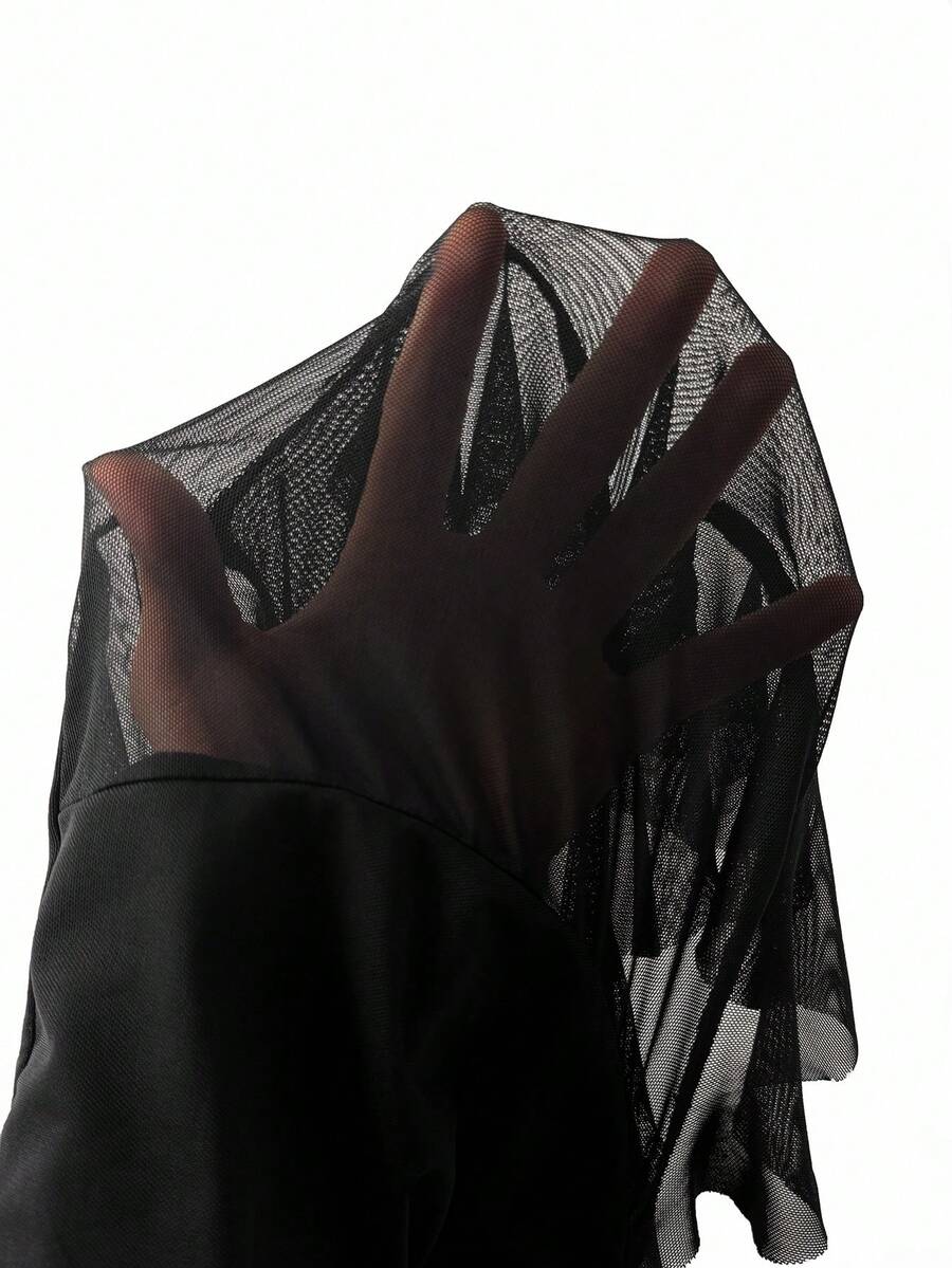 Women's plus size black mesh tank top featuring spaghetti straps, a backless knot detail, and an asymmetrical ruffled hem.