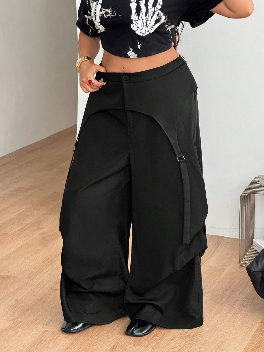 Women's plus size black wide leg parachute pants featuring an asymmetric high waist design in woven fabric.
