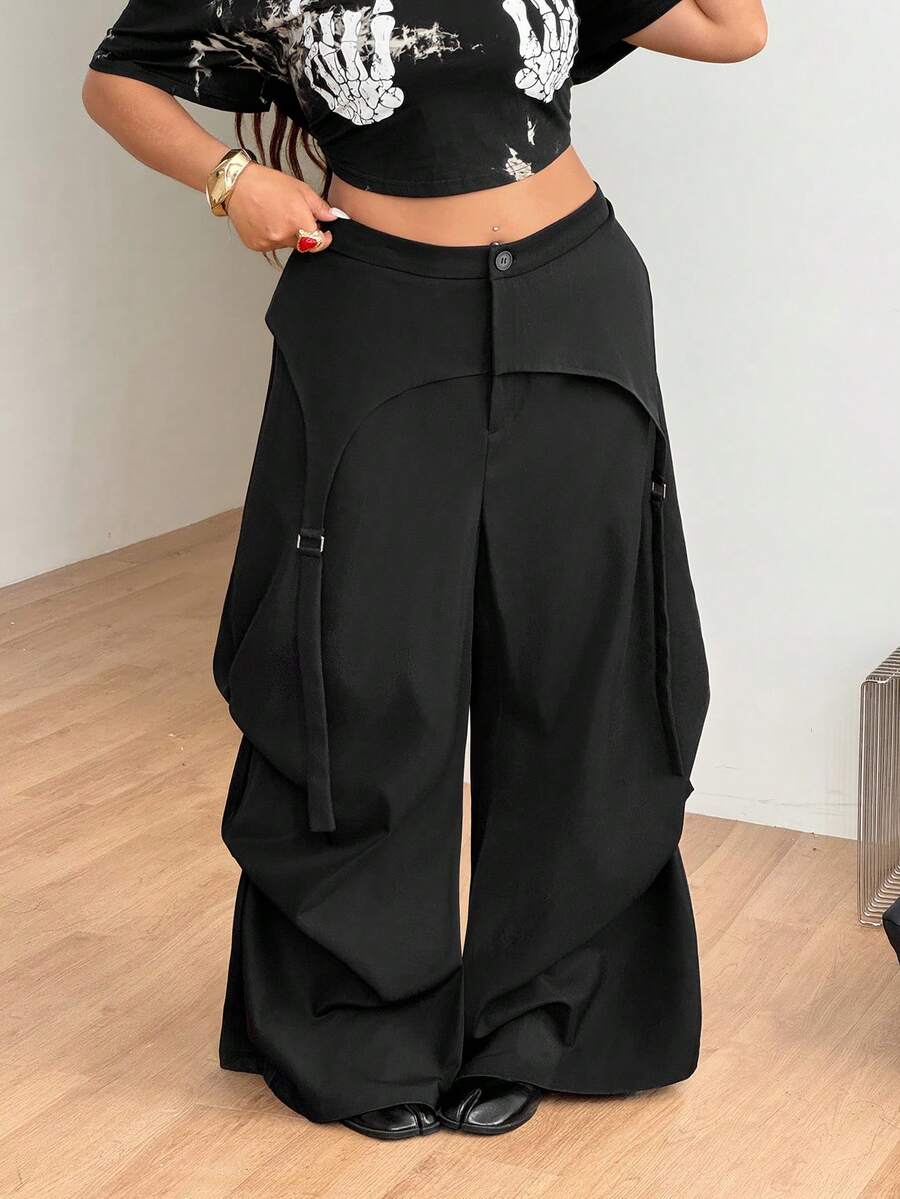 Women's plus size black wide leg parachute pants featuring an asymmetric high waist design in woven fabric.