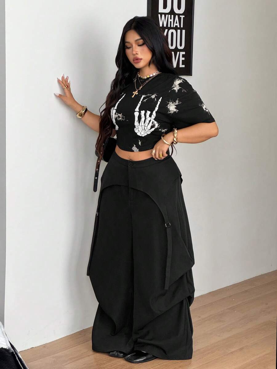 Women's plus size black wide leg parachute pants featuring an asymmetric high waist design in woven fabric.