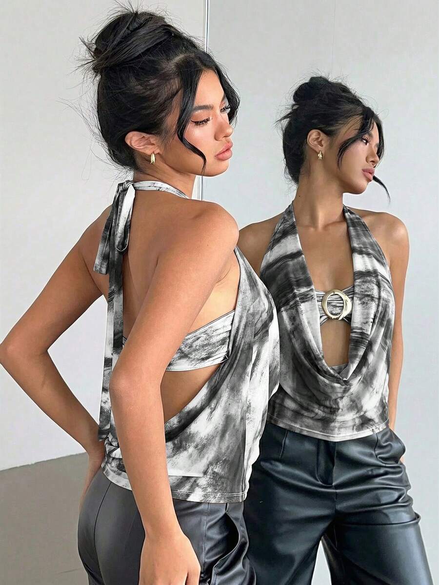 Brown and white polka dot semi-sheer halter camisole top with a plunging neckline, backless design, draped front, and metallic studded embellishments.