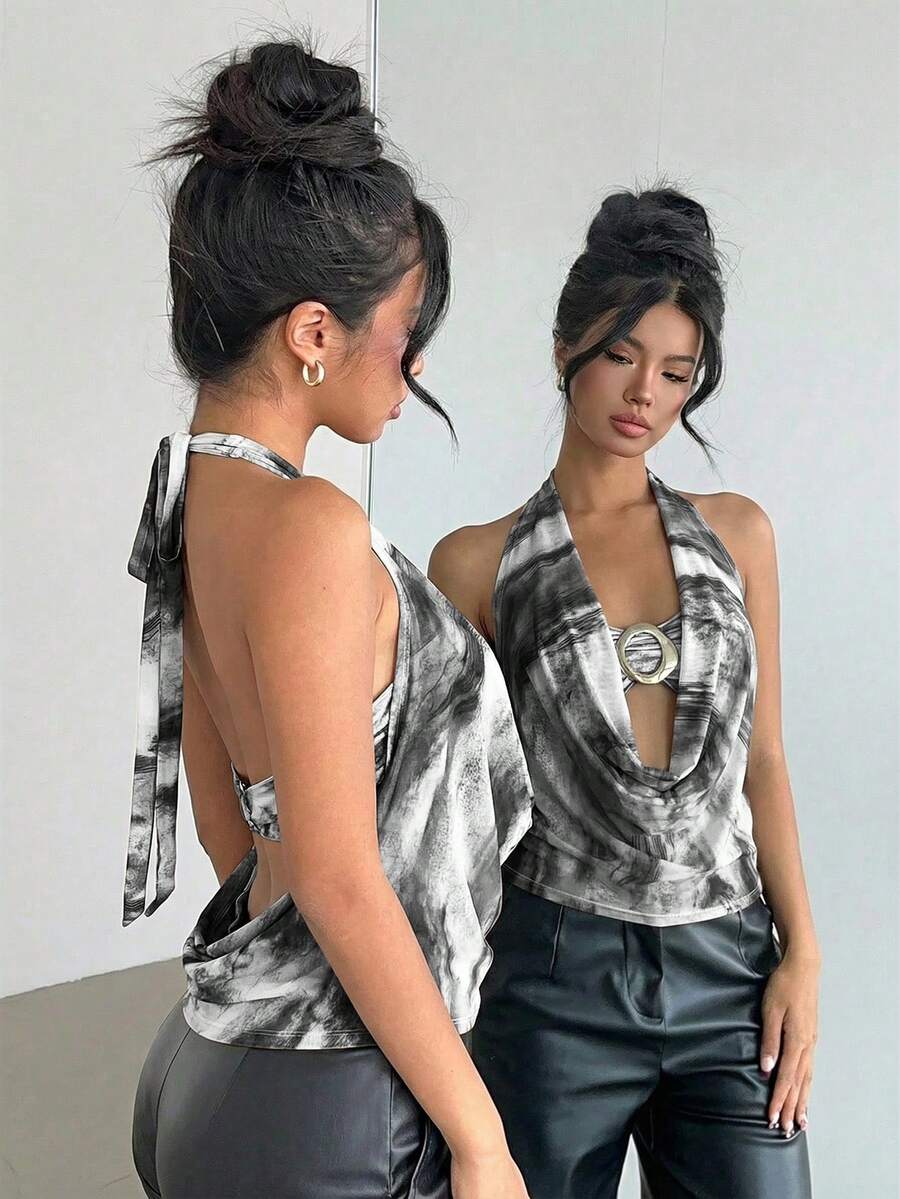Brown and white polka dot semi-sheer halter camisole top with a plunging neckline, backless design, draped front, and metallic studded embellishments.